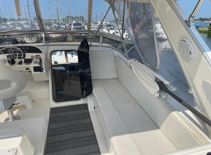  Yacht Photos Pics 2005 Meridian 490 Pilothouse interior with helm, seating, and marina view.