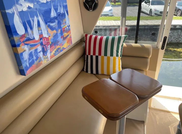  Yacht Photos Pics Interior of 2005 Meridian 490 Pilothouse with colorful pillow and nautical artwork.