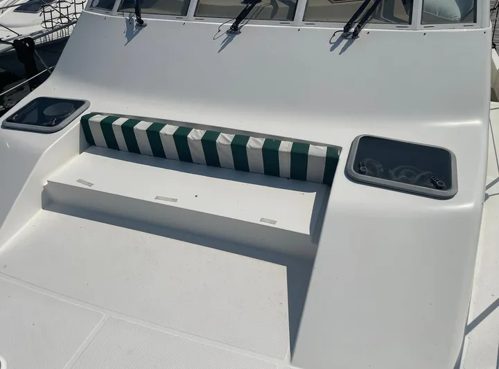  Yacht Photos Pics 2005 Meridian 490 Pilothouse boat deck with striped cushion and storage compartments.