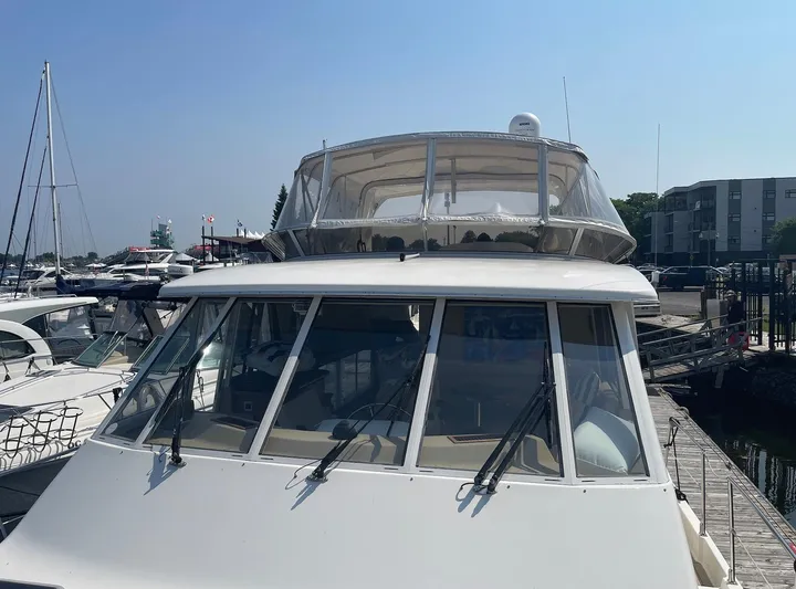  Yacht Photos Pics 2005 Meridian 490 Pilothouse yacht docked at a marina under clear blue skies.
