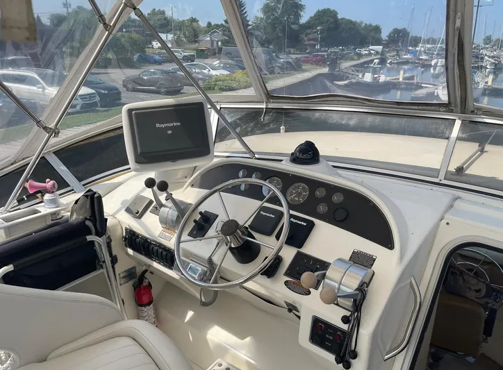  Yacht Photos Pics 2005 Meridian 490 Pilothouse helm with Raymarine electronics and marina view.