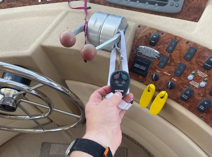  Yacht Photos Pics Pilothouse controls of a 2005 Meridian 490 with steering wheel and remote.