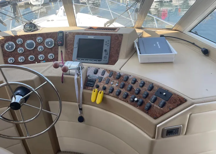  Yacht Photos Pics 2005 Meridian 490 Pilothouse helm with steering wheel, controls, and navigation equipment.