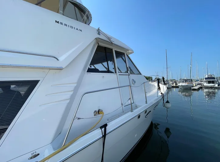  Yacht Photos Pics 2005 Meridian 490 Pilothouse yacht docked in a marina under clear blue skies.