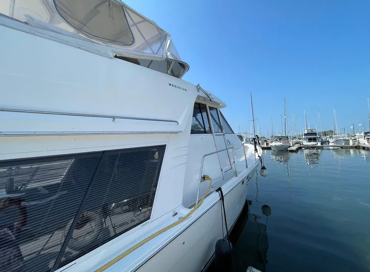  Yacht Photos Pics 2005 Meridian 490 Pilothouse yacht docked in a marina under clear blue skies.