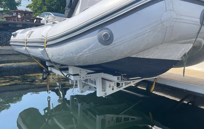  Yacht Photos Pics Inflatable boat on davit system, 2005 Meridian 490 Pilothouse, docked by water.
