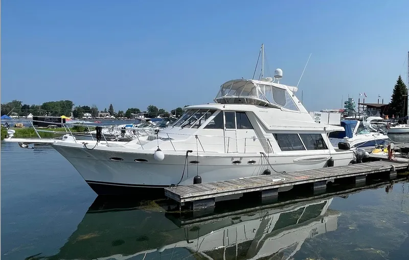  Yacht Photos Pics 2005 Meridian 490 Pilothouse yacht docked in a marina under clear blue skies.