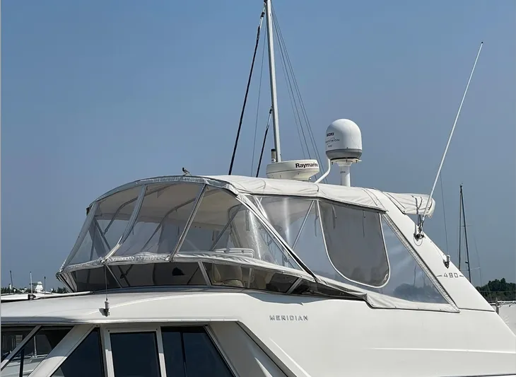  Yacht Photos Pics 2005 Meridian 490 Pilothouse yacht with enclosed flybridge, docked under clear skies.