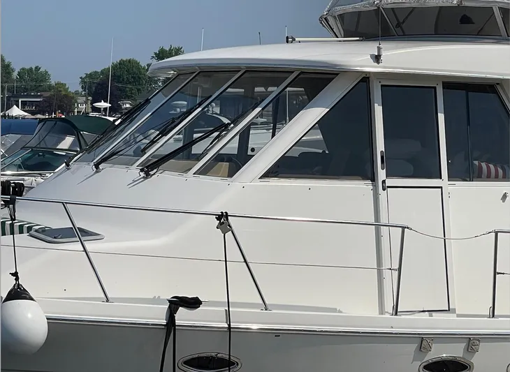  Yacht Photos Pics 2005 Meridian 490 Pilothouse yacht docked, showcasing sleek design and large windows.