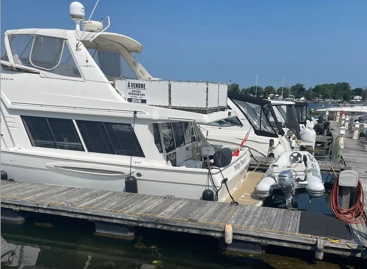  Yacht Photos Pics 2005 Meridian 490 Pilothouse yacht docked, for sale sign visible, sunny day at marina.