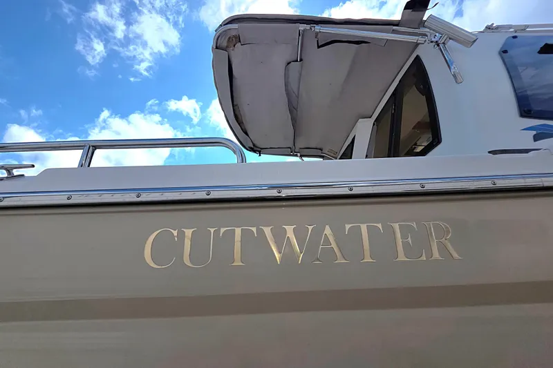  Yacht Photos Pics 2020 Cutwater C-24 boat with canopy against a blue sky background.