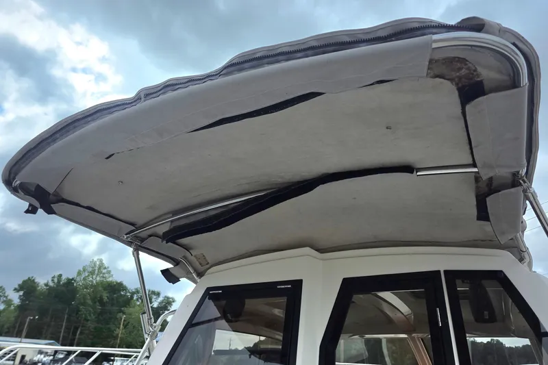  Yacht Photos Pics 2020 Cutwater C-24 boat with a partially open canvas roof under cloudy sky.