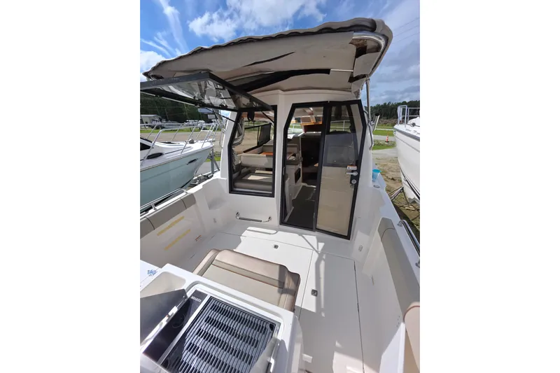  Yacht Photos Pics 2020 Cutwater C-24 boat interior with seating and canopy under a clear sky.