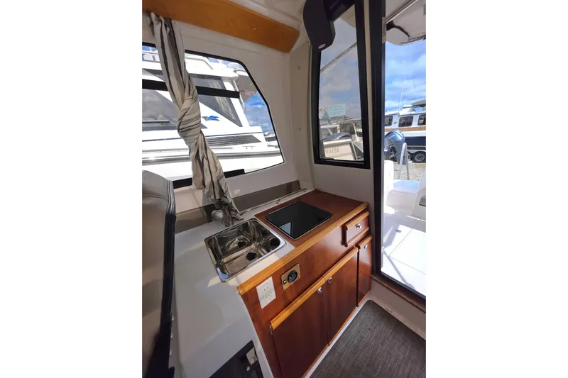  Yacht Photos Pics Interior view of 2020 Cutwater C-24 boat featuring a compact kitchen area.