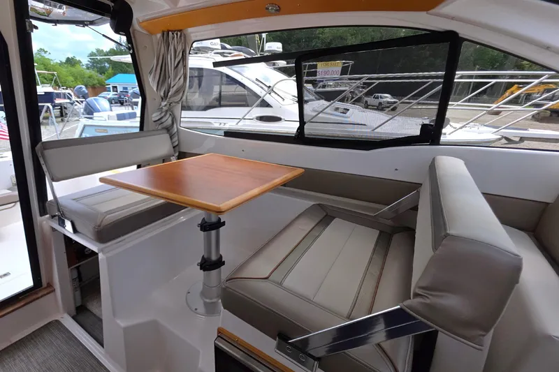  Yacht Photos Pics Interior of a 2020 Cutwater C-24 boat with seating and a wooden table.