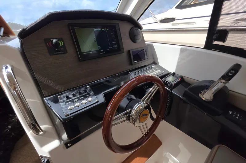  Yacht Photos Pics 2020 Cutwater C-24 helm with navigation controls and wooden steering wheel.