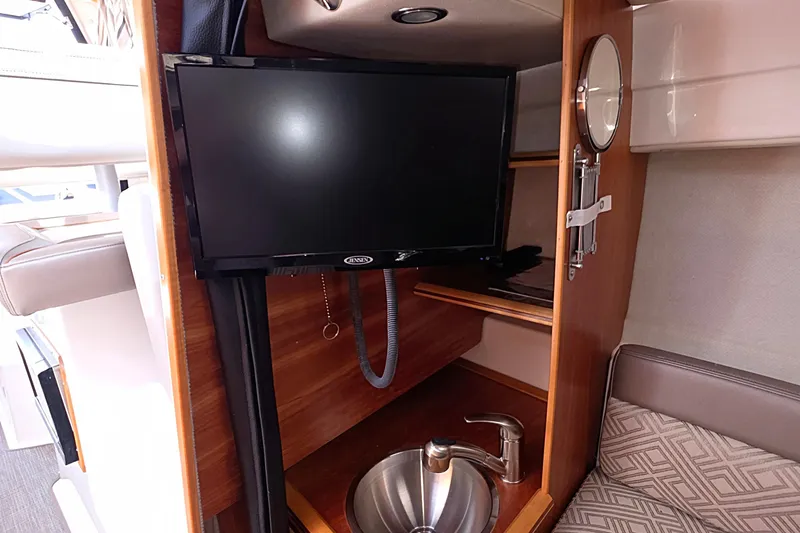  Yacht Photos Pics Interior of 2020 Cutwater C-24 boat featuring a TV, sink, and seating area.