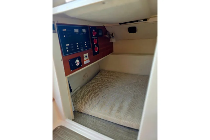  Yacht Photos Pics 2020 Cutwater C-24 cabin interior with control panel and cushioned sleeping area.