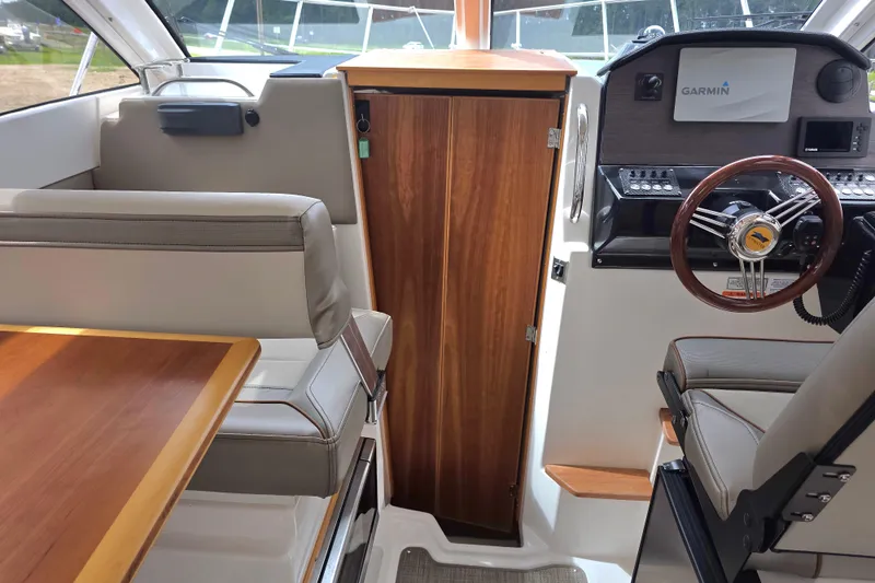  Yacht Photos Pics Interior of 2020 Cutwater C-24 boat with steering wheel and seating area.