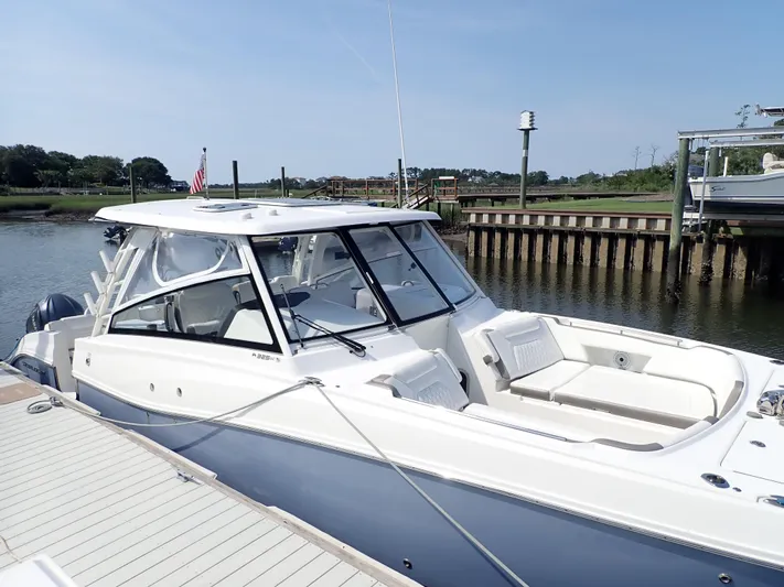 2022 World Cat 325 Dc Yacht Photos Pics 2022 World Cat 325 DC boat docked by a serene waterfront.