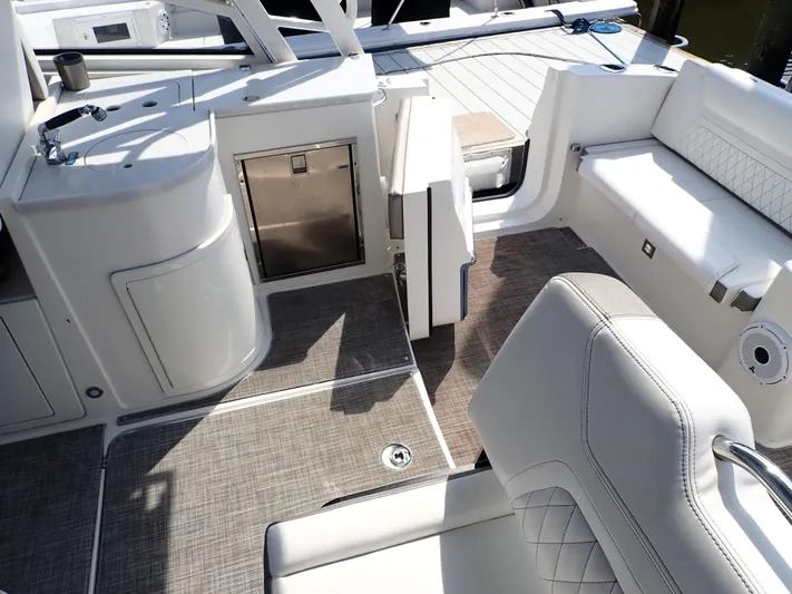 2022 World Cat 325 Dc Yacht Photos Pics 2022 World Cat 325 DC boat interior with seating, sink, and storage.