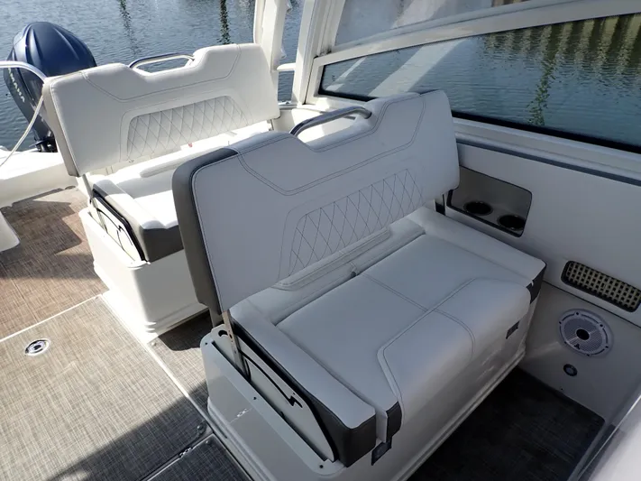 2022 World Cat 325 Dc Yacht Photos Pics 2022 World Cat 325 DC boat interior with white cushioned seating and cup holders.