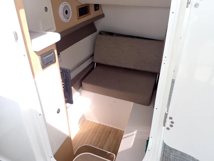 2022 World Cat 325 Dc Yacht Photos Pics Interior cabin of 2022 World Cat 325 DC boat with seating and wooden flooring.