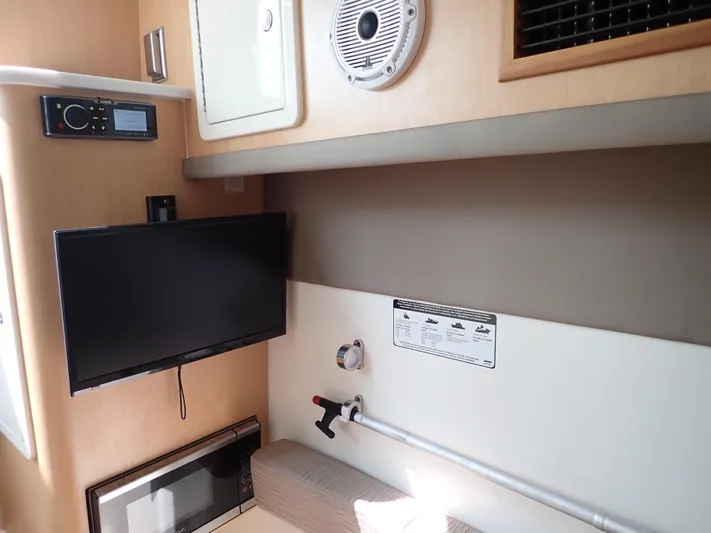 2022 World Cat 325 Dc Yacht Photos Pics Interior of 2022 World Cat 325 DC boat with TV, speaker, and microwave.