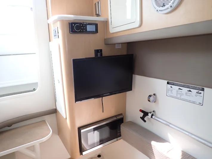 2022 World Cat 325 Dc Yacht Photos Pics 2022 World Cat 325 DC interior with TV, microwave, and seating area.