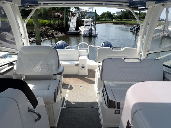 2022 World Cat 325 Dc Yacht Photos Pics Interior view of 2022 World Cat 325 DC boat, featuring luxurious seating and scenic waterway.