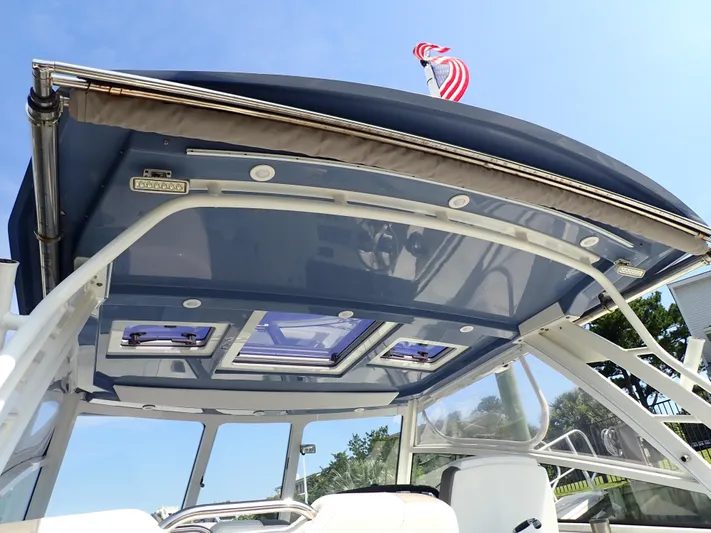 2022 World Cat 325 Dc Yacht Photos Pics 2022 World Cat 325 DC boat canopy with skylights and American flag.
