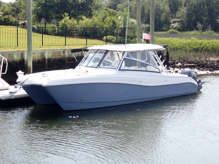 2022 World Cat 325 Dc Yacht Photos Pics 2022 World Cat 325 DC boat docked in a serene marina setting.