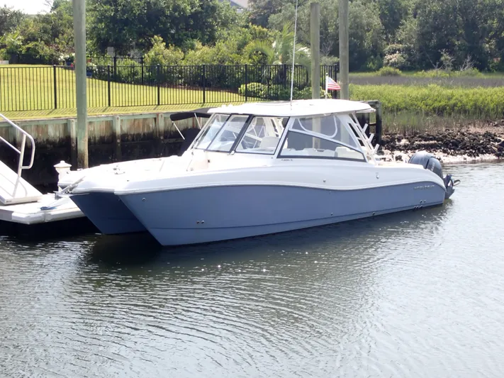 2022 World Cat 325 Dc Yacht Photos Pics 2022 World Cat 325 DC boat docked in a serene marina setting.