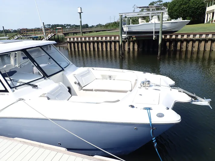 2022 World Cat 325 Dc Yacht Photos Pics 2022 World Cat 325 DC boat docked in a serene marina setting.