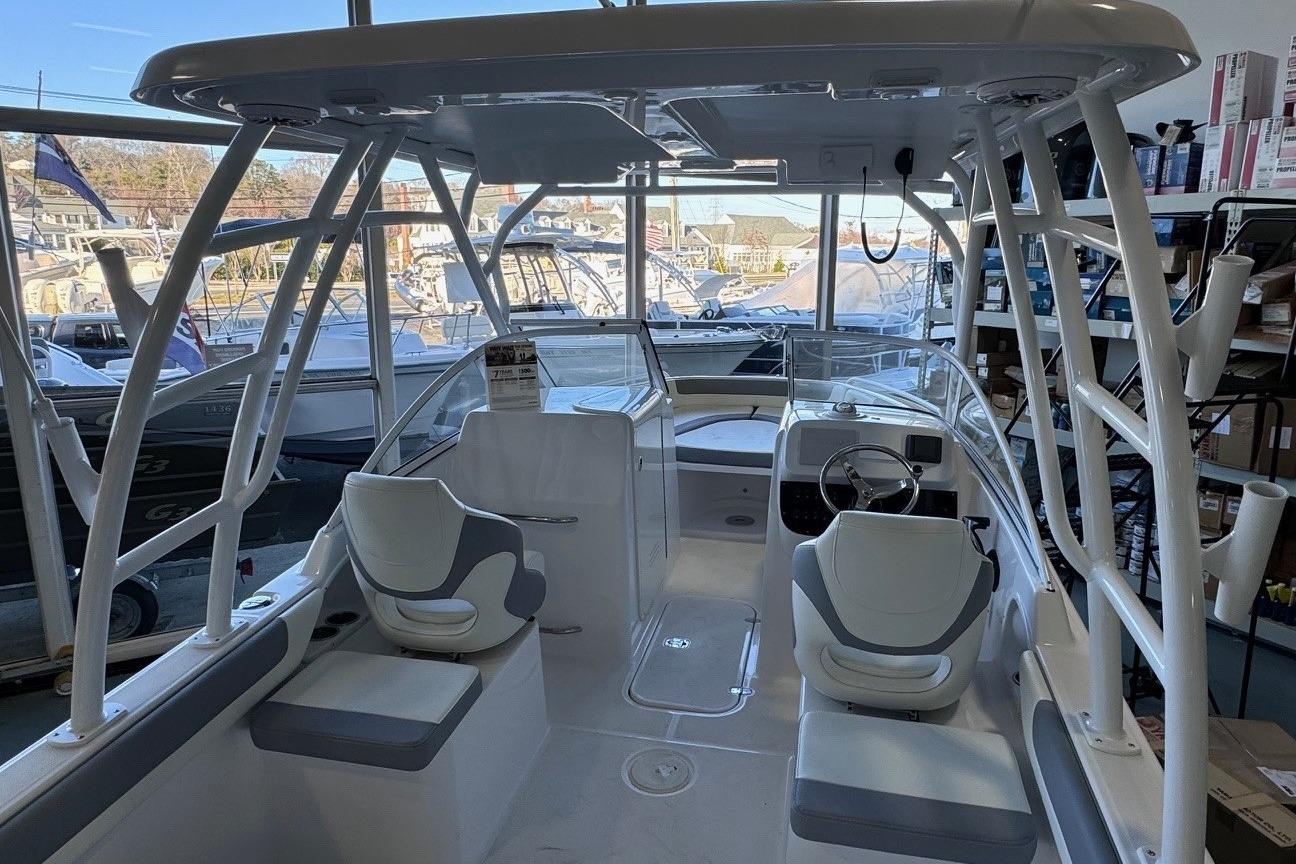 Interior view of 2023 Release 230 DC boat with seating and steering wheel.