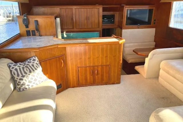Rebel Child Yacht Photos Pics Interior of 1988 Buddy Davis 47 Custom Carolina yacht with wood paneling and seating area.