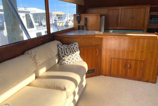 Rebel Child Yacht Photos Pics Interior of 1988 Buddy Davis 47 Custom Carolina yacht with beige sofa and wooden cabinetry.