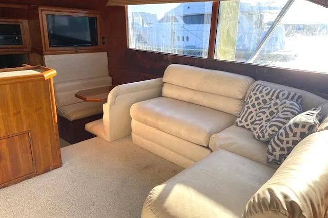 Rebel Child Yacht Photos Pics Interior of 1988 Buddy Davis 47 Custom Carolina yacht with beige sofa and TV.