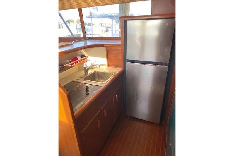 Rebel Child Yacht Photos Pics Galley kitchen in 1988 Buddy Davis 47 Custom Carolina boat with sink and fridge.