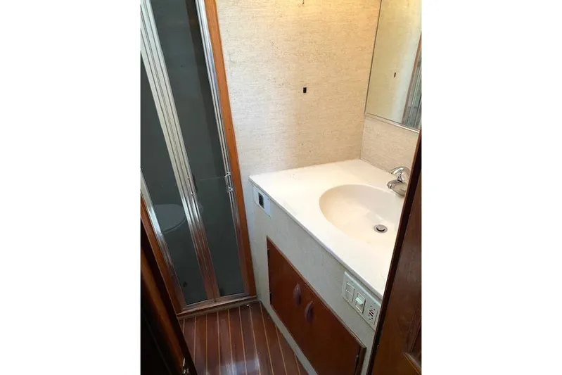Rebel Child Yacht Photos Pics Bathroom interior of 1988 Buddy Davis 47 Custom Carolina yacht, featuring sink and shower.