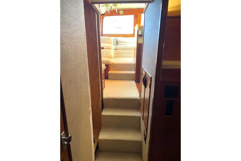 Rebel Child Yacht Photos Pics Interior of 1988 Buddy Davis 47 Custom Carolina yacht with carpeted stairs and seating area.