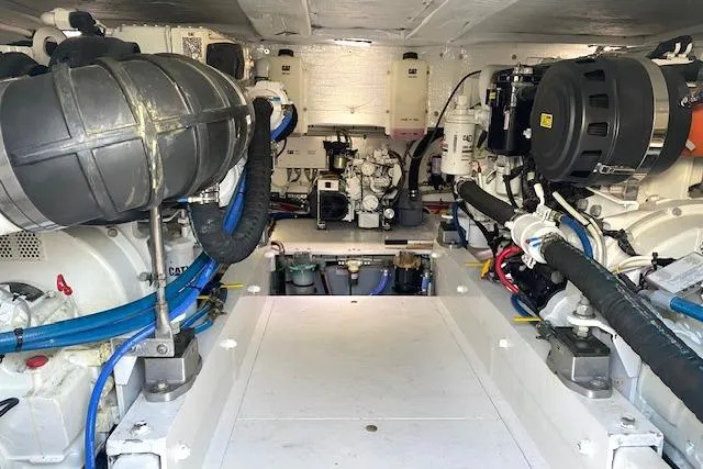 Rebel Child Yacht Photos Pics Engine room of 1988 Buddy Davis 47 Custom Carolina boat, showcasing mechanical components.