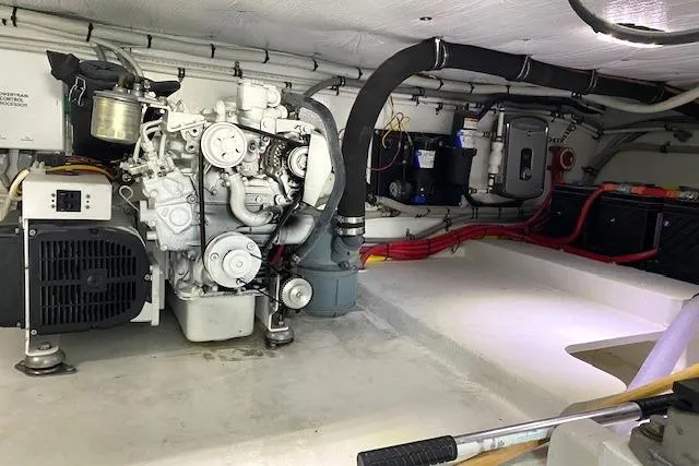 Rebel Child Yacht Photos Pics Engine room of 1988 Buddy Davis 47 Custom Carolina boat, showcasing mechanical components.