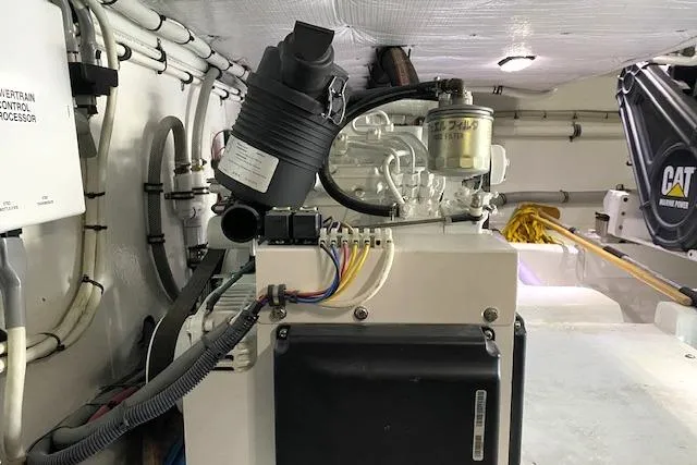 Rebel Child Yacht Photos Pics Engine room of 1988 Buddy Davis 47 Custom Carolina boat, showcasing mechanical components.