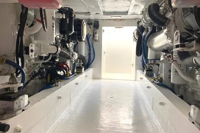 Rebel Child Yacht Photos Pics Engine room of 1988 Buddy Davis 47 Custom Carolina yacht, showcasing mechanical components.