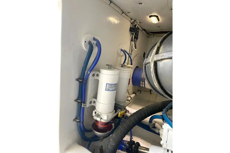 Rebel Child Yacht Photos Pics Engine room of 1988 Buddy Davis 47 Custom Carolina with filters and hoses.