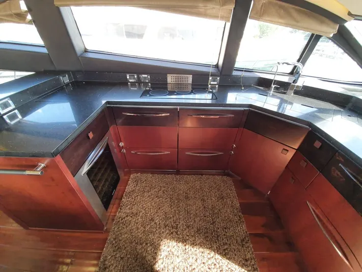 Zen Yacht Photos Pics Luxurious kitchen interior of 2015 Sea Ray L650 Fly yacht with sleek countertops.