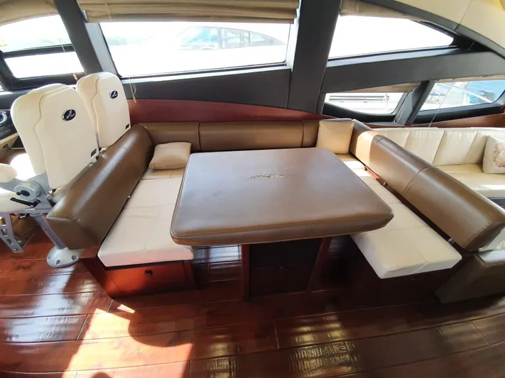 Zen Yacht Photos Pics Luxurious interior of 2015 Sea Ray L650 Fly yacht with elegant seating and table.