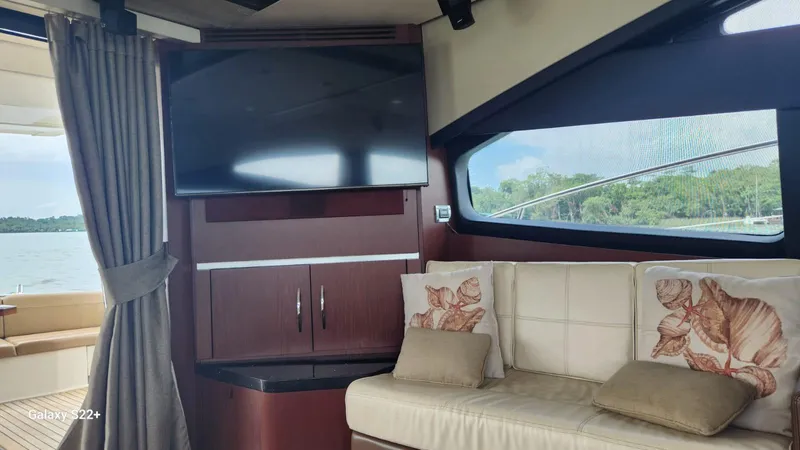 Zen Yacht Photos Pics Luxurious 2015 Sea Ray L650 Fly yacht interior with TV, sofa, and scenic window view.