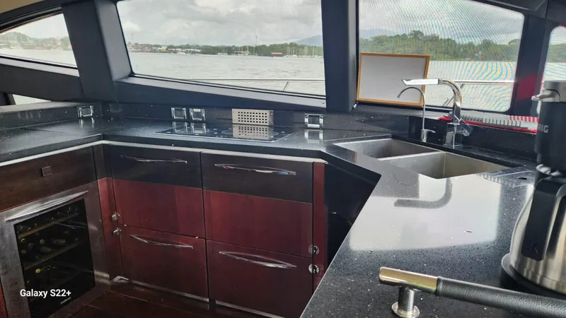 Zen Yacht Photos Pics Luxurious kitchen interior of 2015 Sea Ray L650 Fly yacht with sleek countertops.